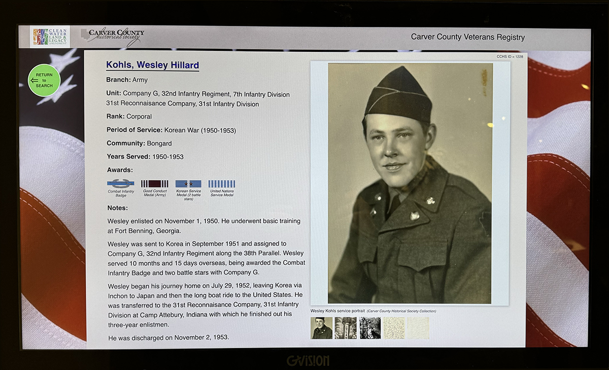Close-up of the Carver County Veteran Registry Kiosk, displaying images, awards, and the story of veteran Wesley Hillard Kohls.